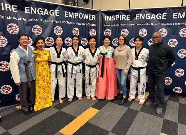 Moses Robinson with taekwondo students and community members at an APAPA Rochester event