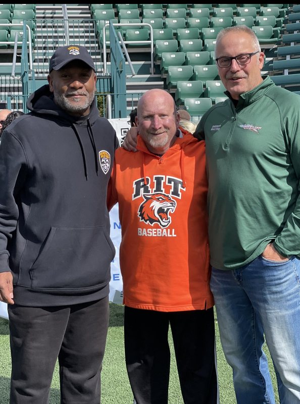 Moses Robinson with RIT baseball coaches at the stadium