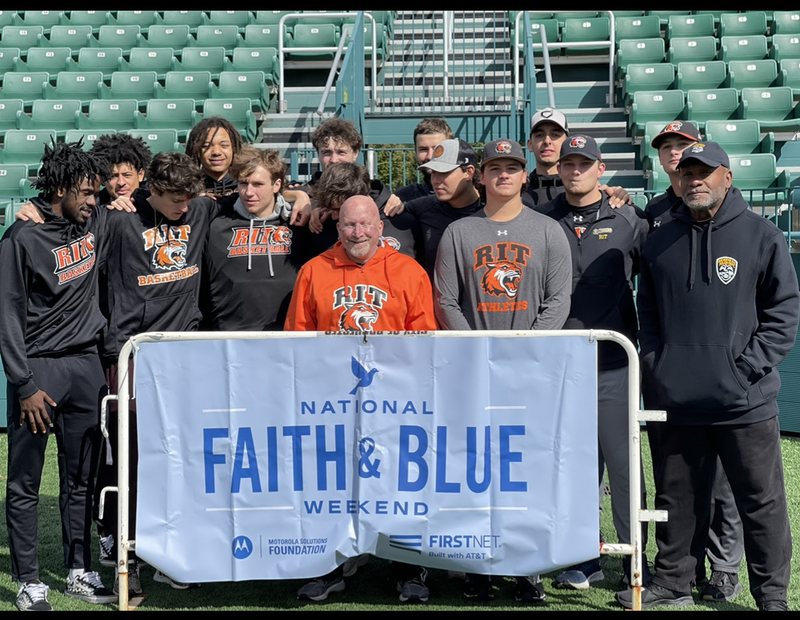 Moses Robinson with the RIT baseball team at a National Faith and Blue Weekend event